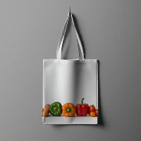 A professional hanging white cotton tote bag mockup featuring a fresh bell pepper vegetable graphic design illustration