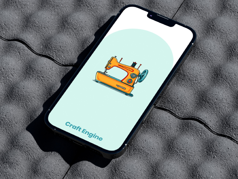 Smartphone mockup resting on a grey egg-crate foam surface, showing the Craft Engine app splash